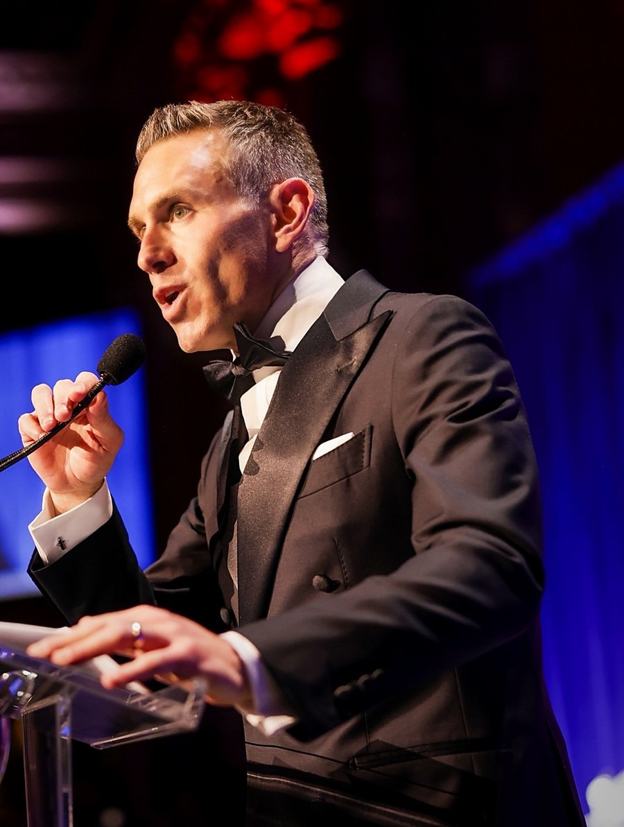 Jason D. Meister speaking at a podium